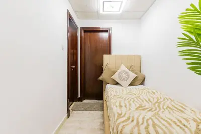a bedroom with a bed and a wooden door at Opal Tower Condos - Dubai Marina in Dubai