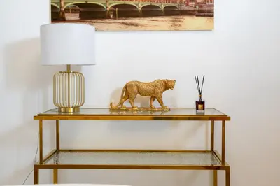 a lion statue on a table with a lamp at Sleep 5 Near Dubai Mall in Dubai