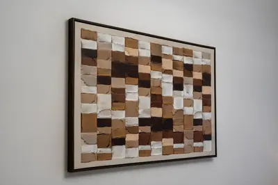 a painting hanging on a white wall at Sleep 5 Near Dubai Mall in Dubai