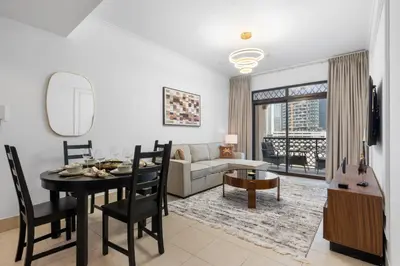 a living room with a table and a couch at Sleep 5 Near Dubai Mall in Dubai