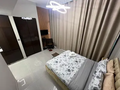 a bedroom with a bed and a couch at Studio in Business Bay with Huge Balcony & Pool View near to Metro in Dubai