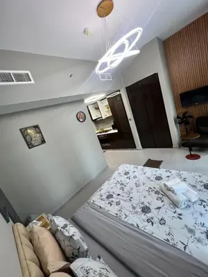 a bedroom with a bed and a ceiling fan at Studio in Business Bay with Huge Balcony & Pool View near to Metro in Dubai