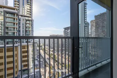 a balcony with a view of a city at Luxury 1BR in Sobha Hartland w Pool & Gym Access in Dubai