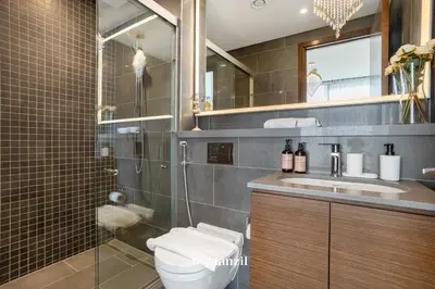 a bathroom with a toilet and a shower and a sink at Luxury 1BR in Sobha Hartland w Pool & Gym Access in Dubai