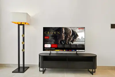 a flat screen tv on a wall in a living room at New, Bright & Cozy 1BD at Paragon by IGO, Dubai in Dubai