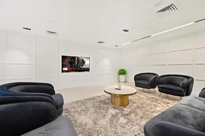 a waiting room with couches and a table and chairs at New, Bright & Cozy 1BD at Paragon by IGO, Dubai in Dubai