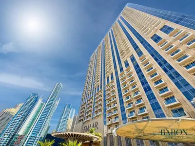 a tall building in front of a city at The Lavish Suite in Dubai