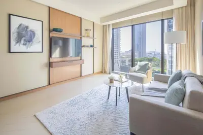a living room with a couch and a tv at Frank Porter - Address Opera Tower in Dubai