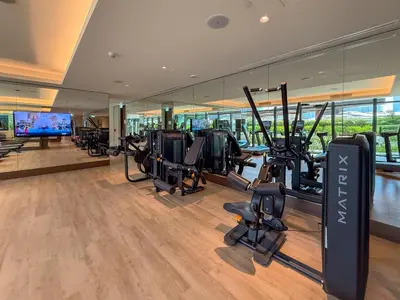 a gym with treadmills and cardio equipment in a building at Frank Porter - Address Opera Tower in Dubai