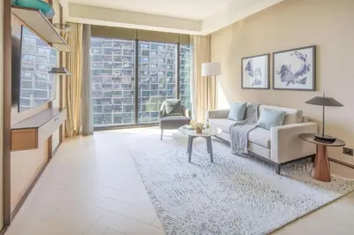 a living room with a couch and a tv at Frank Porter - Address Opera Tower in Dubai