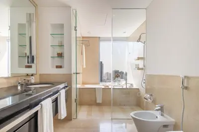 a bathroom with a shower and a toilet and a sink at Frank Porter - Marina Mall Hotel in Dubai