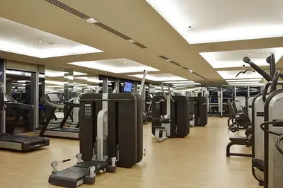 a gym with a bunch of treadmills and machines at Frank Porter - Marina Mall Hotel in Dubai