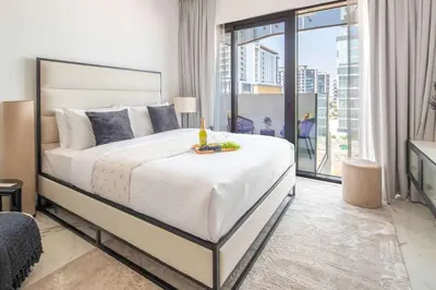 a bedroom with a large bed and a balcony at Frank Porter - Azizi Riviera 51, Meydan in Dubai