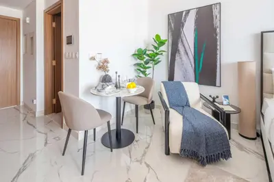 a dining room with a table and chairs at Frank Porter - Azizi Riviera 51, Meydan in Dubai