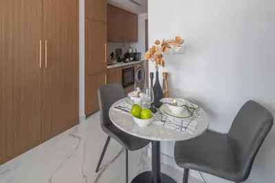 a kitchen with a table with fruit on it at Frank Porter - Azizi Riviera Azure, Meydan in Dubai