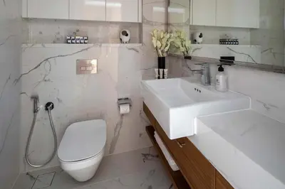 a white bathroom with a sink and a toilet at Frank Porter - Azizi Riviera Azure, Meydan in Dubai