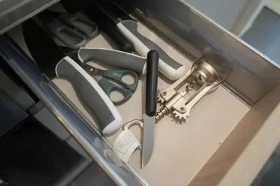 a group of scissors and a gun hanging from a door at Premium 1BR Stay with Balcony & City View, Nad Al Sheba in Dubai