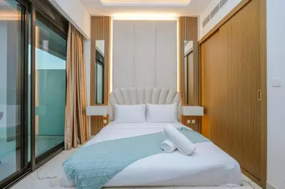 a bedroom with a bed and a window at NEW! Studio in Azizi Riviera 59 in Dubai