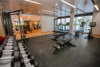 a gym with several exercise bikes and treadmills at NEW! Studio in Azizi Riviera 59 in Dubai