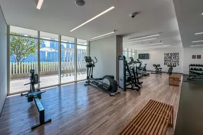 a gym with treadmills and ellipticals in a building at Luxury 3BR plus Maids Room in Emaar Beachfront in Dubai
