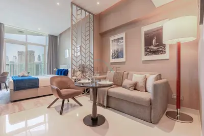 a living room with a couch and a table at Full Canal Views, Minutes from Downtown and Burj Khalifa, Close to Metro Station - Prive By Damac B, Business Bay by Deluxe Holiday Homes in Dubai