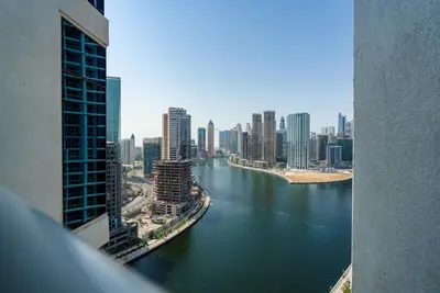 a view of a river in a city with buildings at Full Canal Views, Minutes from Downtown and Burj Khalifa, Close to Metro Station - Prive By Damac B, Business Bay by Deluxe Holiday Homes in Dubai
