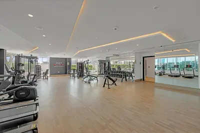 a gym with treadmills and exercise equipment in a building at Opal by Danube | Designer 1BR | Private Jacuzz in Dubai