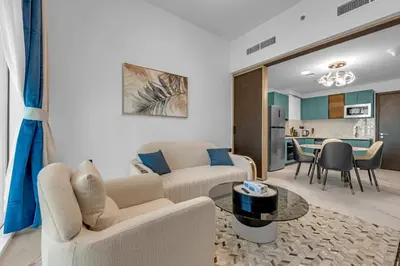 a living room with a couch and a table at Opal by Danube | Designer 1BR | Private Jacuzz in Dubai