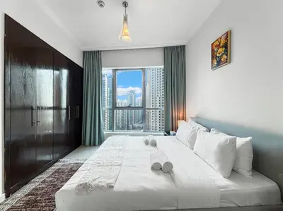 a bedroom with a large bed with a large window at 2204 DXB Marina, KingBed, Steps to Tram, Clubs & Dining, Bay Central in Dubai