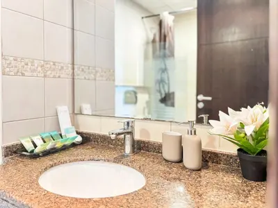 a bathroom counter with a sink and a mirror at 2204 DXB Marina, KingBed, Steps to Tram, Clubs & Dining, Bay Central in Dubai