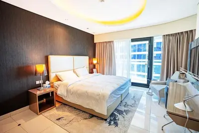 a hotel room with a bed and a television at Exquisite 1BR at DAMAC Paramount Tower D in Dubai