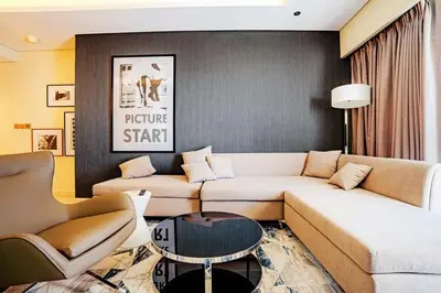 a living room with a couch and a table at Exquisite 1BR at DAMAC Paramount Tower D in Dubai