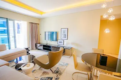 a living room with a couch and a table at Exquisite 1BR at DAMAC Paramount Tower D in Dubai
