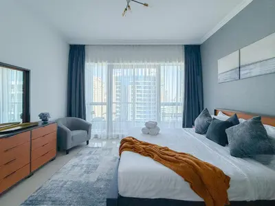 a bedroom with a large bed and a large window at Marina View-2BR,6 Guests, Central location, Marina Walk in Dubai