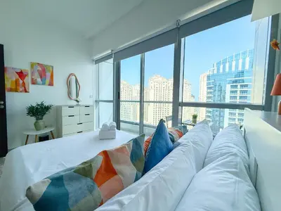 a large white couch in a room with a large window at Marina View-2BR,6 Guests, Central location, Marina Walk in Dubai