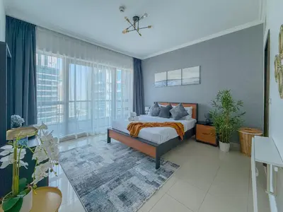 a bedroom with a bed and a large window at Marina View-2BR,6 Guests, Central location, Marina Walk in Dubai