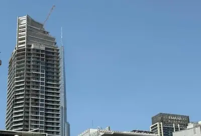 a tall building is under construction in a city at Premium Studio Majestine by DAMAC, Business Hub in Dubai