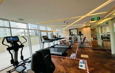 a gym with treadmills and machines in a room at Premium Studio Majestine by DAMAC, Business Hub in Dubai