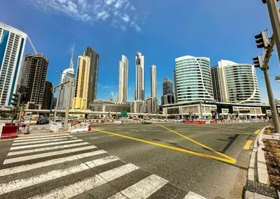 an empty street in a city with tall buildings at Premium Studio Majestine by DAMAC, Business Hub in Dubai