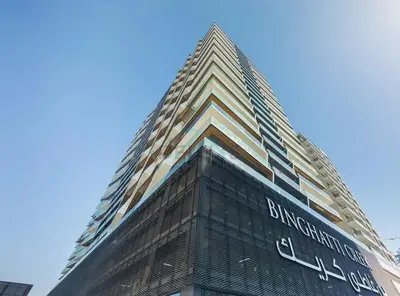 a tall building with a sign on the side of it at Creek Harbour Views 1BR, Just Minutes from Ras Al Khor Wildlife Sanctuary and Short Stroll to Zabeel Stadium, Binghatti Creek, Al Jaddaf by Deluxe Holiday Homes in Dubai