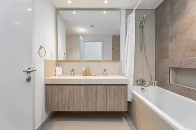 a bathroom with a sink and a tub and a mirror at Luxury 3 bed with Burj Khalifa and Dubai Skyline View in Dubai