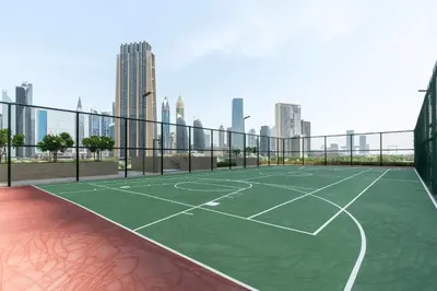 a tennis court with a city skyline in the background at Luxury 3 bed with Burj Khalifa and Dubai Skyline View in Dubai