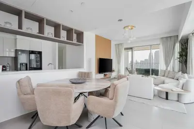 a kitchen and living room with a table and chairs at Luxury 3 bed with Burj Khalifa and Dubai Skyline View in Dubai