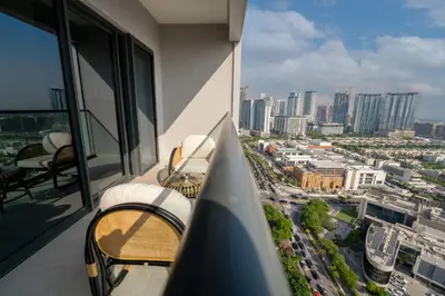 a balcony of a building with a view of a city at EasyGo - Stylish 2BR With City View in Sobha Creek in Dubai