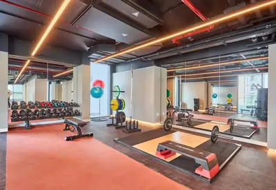 a gym with lots of exercise equipment in a room at EasyGo - Stylish 2BR With City View in Sobha Creek in Dubai