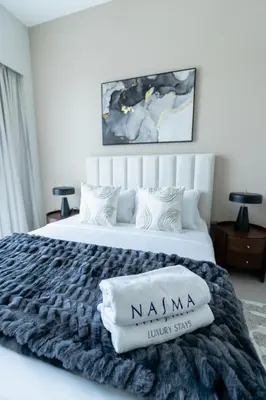 a bedroom with a king sized bed with a nanny junior suite at Nasma Luxury stays- Luxury-highfloor-iconic location in Dubai