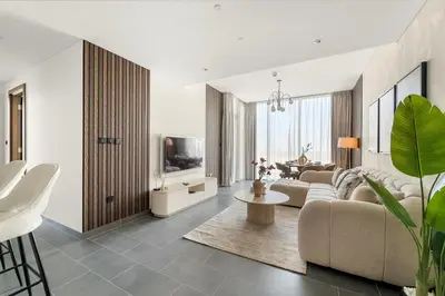 a living room with a couch and a table at FIRST CLASS 3BR Stylish Luxury Escape in Dubai