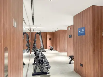 a gym with treadmills and machines in a building at FIRST CLASS 3BR Stylish Luxury Escape in Dubai