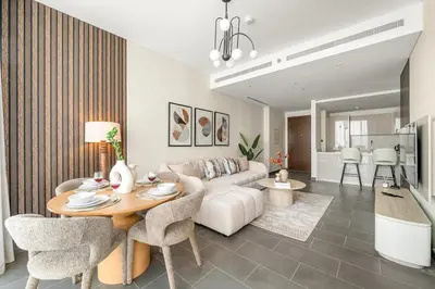 a living room with a couch and a table at FIRST CLASS 3BR Stylish Luxury Escape in Dubai