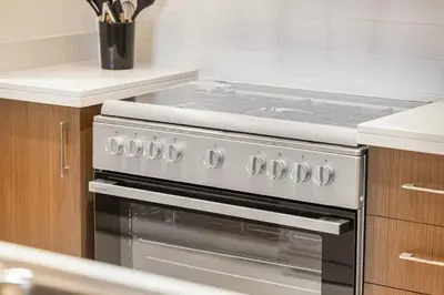 a kitchen with a stove top oven in a kitchen at Forte 4BR Luxury Dubai Opera & BLVD Views PS5 in Dubai